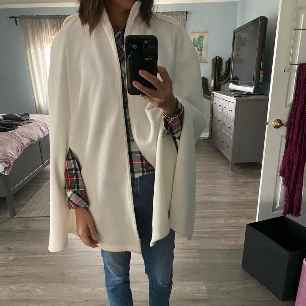 Cream fleece cape with pockets and zipper.
